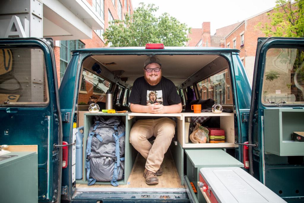 man inside of van with doors open